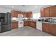 Kitchen with wood cabinets, white appliances, and gray floor at 361 Preserve Pointe Blvd, Davenport, FL 33837