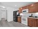 Kitchen with wood cabinets, and white appliances at 361 Preserve Pointe Blvd, Davenport, FL 33837