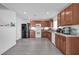 Kitchen with wood cabinets, white appliances, and gray floor at 361 Preserve Pointe Blvd, Davenport, FL 33837