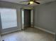 Bedroom with ceiling fan, mirrored closet doors, neutral decor, and blinds at 4826 Marks Terrace # 389, Orlando, FL 32811