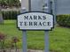 Marks Terrace sign with lush green lawn and tidy landscaping on a sunny day at 4826 Marks Terrace # 389, Orlando, FL 32811