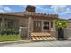 Community center's pergola-covered entrance featuring steps and manicured landscaping at 4826 Marks Terrace # 389, Orlando, FL 32811
