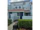 Inviting two-story condo with a red tile roof, blue painted stucco, and manicured landscaping at 4826 Marks Terrace # 389, Orlando, FL 32811