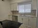 Kitchen with stainless steel appliances, white cabinets, tiled backsplash and countertops at 4826 Marks Terrace # 389, Orlando, FL 32811