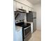 Well-equipped kitchen featuring modern appliances, granite countertops and white cabinetry at 4826 Marks Terrace # 389, Orlando, FL 32811