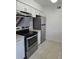 Well-equipped kitchen with stainless steel appliances and white cabinets at 4826 Marks Terrace # 389, Orlando, FL 32811