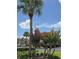 View of the community landscaping featuring trees, bushes, and a parking lot in the background at 4826 Marks Terrace # 389, Orlando, FL 32811