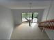 Spacious living room boasts tile floors, soaring ceilings, and access to a private balcony with serene outdoor views at 4826 Marks Terrace # 389, Orlando, FL 32811