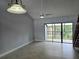 Bright living room features neutral tile flooring and sliding glass doors to the lanai at 4826 Marks Terrace # 389, Orlando, FL 32811
