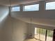 Bright living area with clerestory windows, vaulted ceilings, and a ceiling fan for optimal comfort and natural light at 4826 Marks Terrace # 389, Orlando, FL 32811