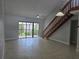 Bright living room with tile floors, ceiling fan, staircase, and sliding glass doors at 4826 Marks Terrace # 389, Orlando, FL 32811