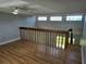 Spacious loft area overlooking the living room, featuring wood floors and great natural light at 4826 Marks Terrace # 389, Orlando, FL 32811