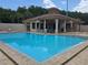 Community pool with a covered lounge area, perfect for relaxation and recreation at 4826 Marks Terrace # 389, Orlando, FL 32811