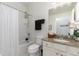 Well-lit bathroom with granite counters, white cabinetry, and a shower-tub combination at 508 Zamora Way, Davenport, FL 33837