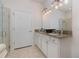 Bright bathroom featuring granite countertops, tiled floors, and a glass-enclosed shower at 508 Zamora Way, Davenport, FL 33837