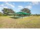 Outdoor bocce ball courts with green shade covers for a comfortable playing experience at 508 Zamora Way, Davenport, FL 33837