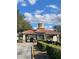 A grand community entrance with stone pillars, manicured bushes, and a decorative fountain is showcased at 508 Zamora Way, Davenport, FL 33837