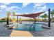 Shallow entry community pool area featuring a sunshade with lounge chairs for relaxation at 508 Zamora Way, Davenport, FL 33837
