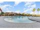Community pool with beach entry, sun umbrellas, and ample seating at 508 Zamora Way, Davenport, FL 33837