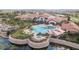 Stunning aerial view of a community pool with plenty of lounge chairs surrounded by palm trees and lush landscaping at 508 Zamora Way, Davenport, FL 33837