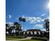 A gorgeous Del Webb entrance sign is surrounded by manicured lawns and palm trees at 508 Zamora Way, Davenport, FL 33837