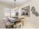 Dining room with decorative light fixture, adjacent to the open kitchen with pass through window at 508 Zamora Way, Davenport, FL 33837