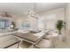 Bright dining area featuring modern chandelier, neutral tones and plantation shutters for an inviting atmosphere at 508 Zamora Way, Davenport, FL 33837