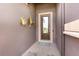 View of the front door entryway featuring decorative art and tiled floor at 508 Zamora Way, Davenport, FL 33837