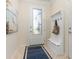 View of the front door entryway with a hall tree bench, area rug and decorative art at 508 Zamora Way, Davenport, FL 33837