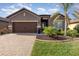 Beautiful single story home with manicured landscaping, a brick driveway and a two car garage at 508 Zamora Way, Davenport, FL 33837