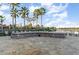 Community stone fire pit and seating area with views of the lake and palm trees at 508 Zamora Way, Davenport, FL 33837