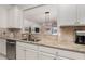 Kitchen with stainless steel appliances and granite countertops, seamlessly connecting to the living space at 508 Zamora Way, Davenport, FL 33837