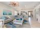 Open-concept living room with ceiling fan, sectional, and an accent rug adjacent to dining area at 508 Zamora Way, Davenport, FL 33837