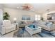 Open-concept living room with ceiling fan, sectional, and an accent rug at 508 Zamora Way, Davenport, FL 33837