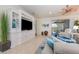 Open-concept living room with built-in shelving unit and sliding glass doors to lanai at 508 Zamora Way, Davenport, FL 33837