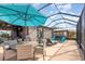 Covered patio featuring comfortable seating, a dining area, and a relaxing hot tub at 508 Zamora Way, Davenport, FL 33837