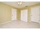 Small unfurnished bedroom with tile floors, light colored walls, two doorways, and a closet at 5403 Moxie Blvd, Orlando, FL 32839