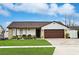 Charming single-story house with a brown roof, stone accents, and a two-car garage at 5403 Moxie Blvd, Orlando, FL 32839