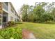 Spacious backyard with lush greenery and a grassy area at 5999 Lake Pointe # 609, Orlando, FL 32822