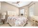 Bedroom with a floral comforter and a home office area at 5999 Lake Pointe # 609, Orlando, FL 32822