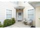 Inviting condo entrance with small patio and seating at 5999 Lake Pointe # 609, Orlando, FL 32822
