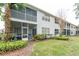Exterior view showing building with screened porch and landscaping at 5999 Lake Pointe # 609, Orlando, FL 32822