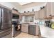Modern kitchen featuring stainless steel appliances and light taupe cabinets at 5999 Lake Pointe # 609, Orlando, FL 32822