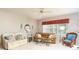 Comfortable living room with leather sofas and a ceiling fan at 5999 Lake Pointe # 609, Orlando, FL 32822