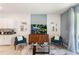 Living room with teal armchairs and a wooden media console at 664 Preston Cove Dr, St Cloud, FL 34771