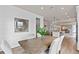 Bright dining room features a rustic wood table and white chairs at 7345 Ivy Tendril Ave, Orlando, FL 32829