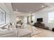Open concept living room with hardwood floors and a view into the kitchen area at 7345 Ivy Tendril Ave, Orlando, FL 32829