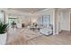 Spacious living room with large windows, hardwood floors, and comfortable seating at 7345 Ivy Tendril Ave, Orlando, FL 32829
