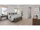 Spacious main bedroom with wood floors and en-suite bathroom at 7345 Ivy Tendril Ave, Orlando, FL 32829