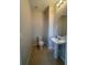 Powder room with a pedestal sink and tiled floors at 8066 Glenlloyd Ave, Winter Garden, FL 34787